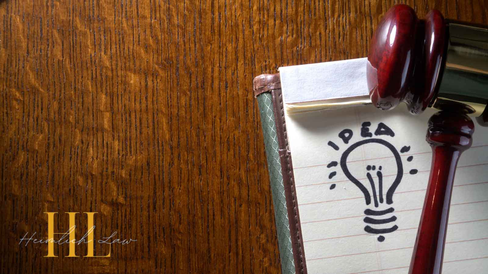 Gavel next to notebook with “Idea” on the page