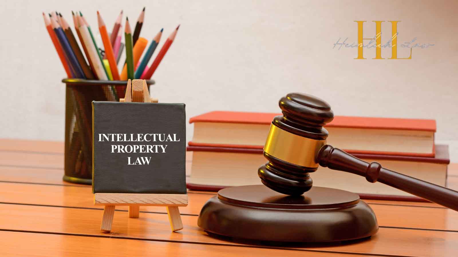 Table with pencils, small chalkboard, gavel, and stacked law books.