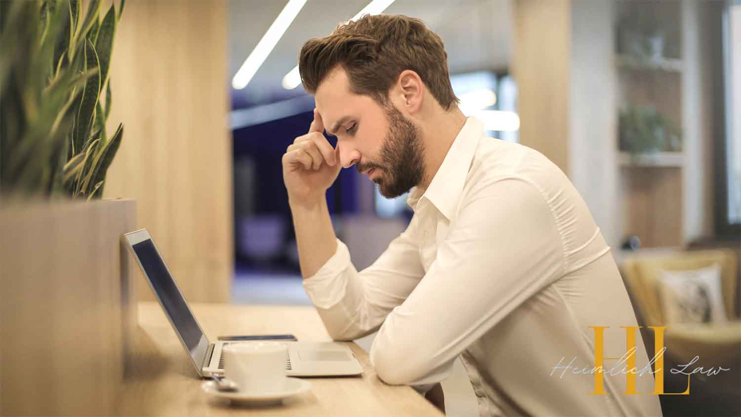 A man sitting at a table with a worried expression