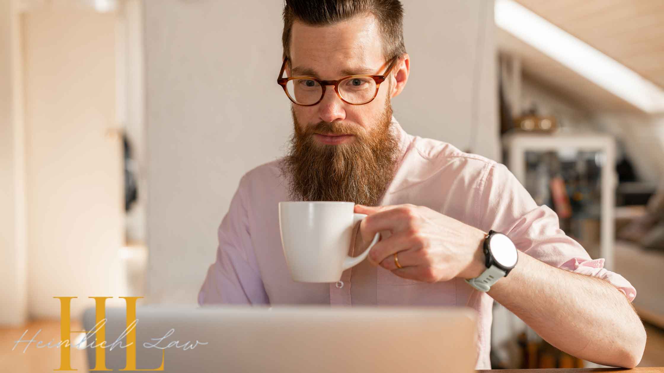 Man sipping coffee while using his home computer to search online