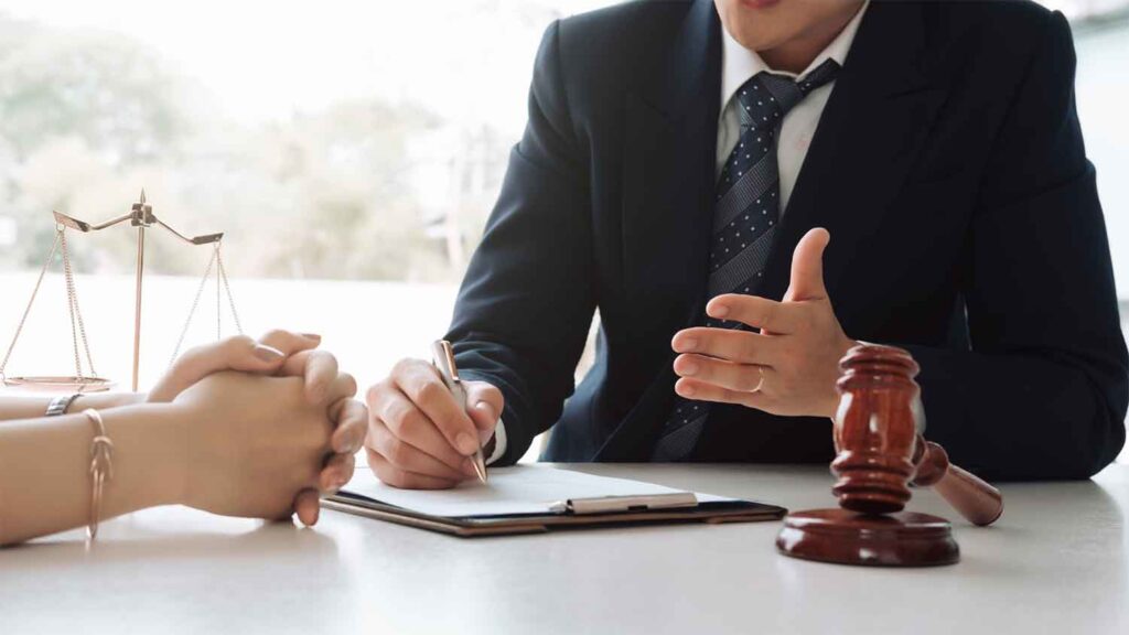 Legal professional speaking with a client in an office setting