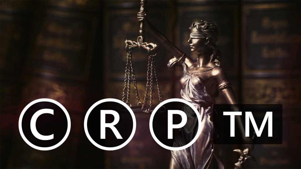 A scale of justice figurine displayed with trademark pattern logos representing intellectual property