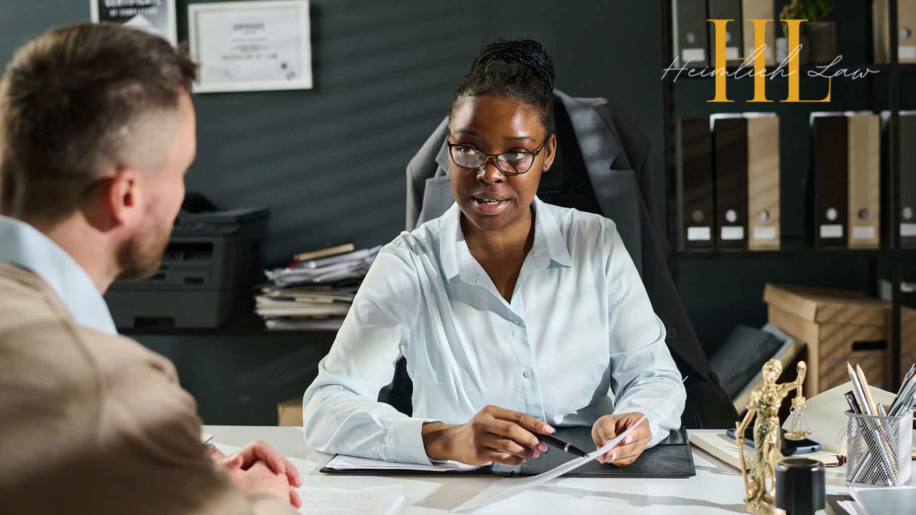 A man talking to a female lawyer in her office