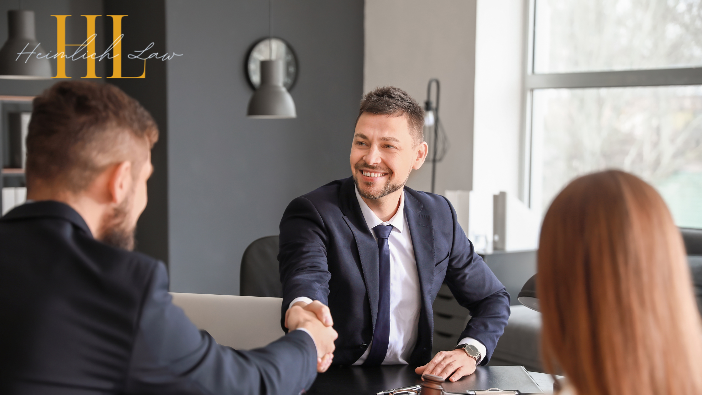 Clients discussing legal matters with a lawyer in a professional office setting.