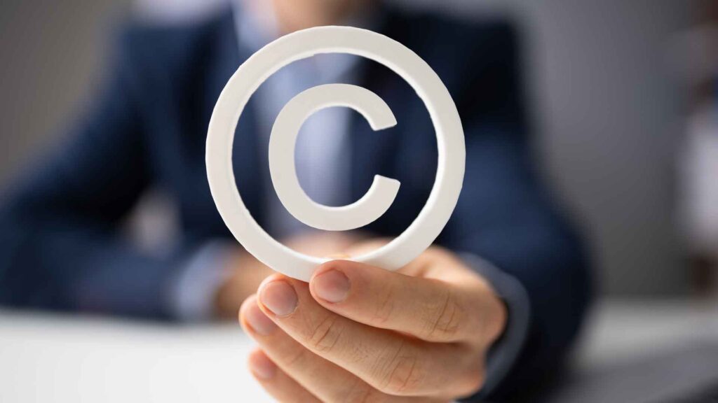 A manโs hands holding a copyright symbol